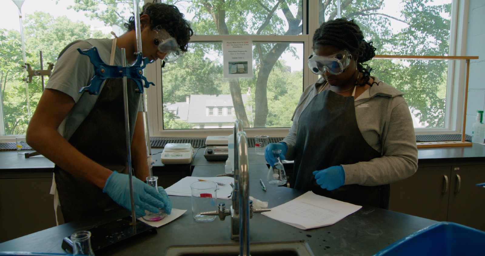 Two students performing an experiment.