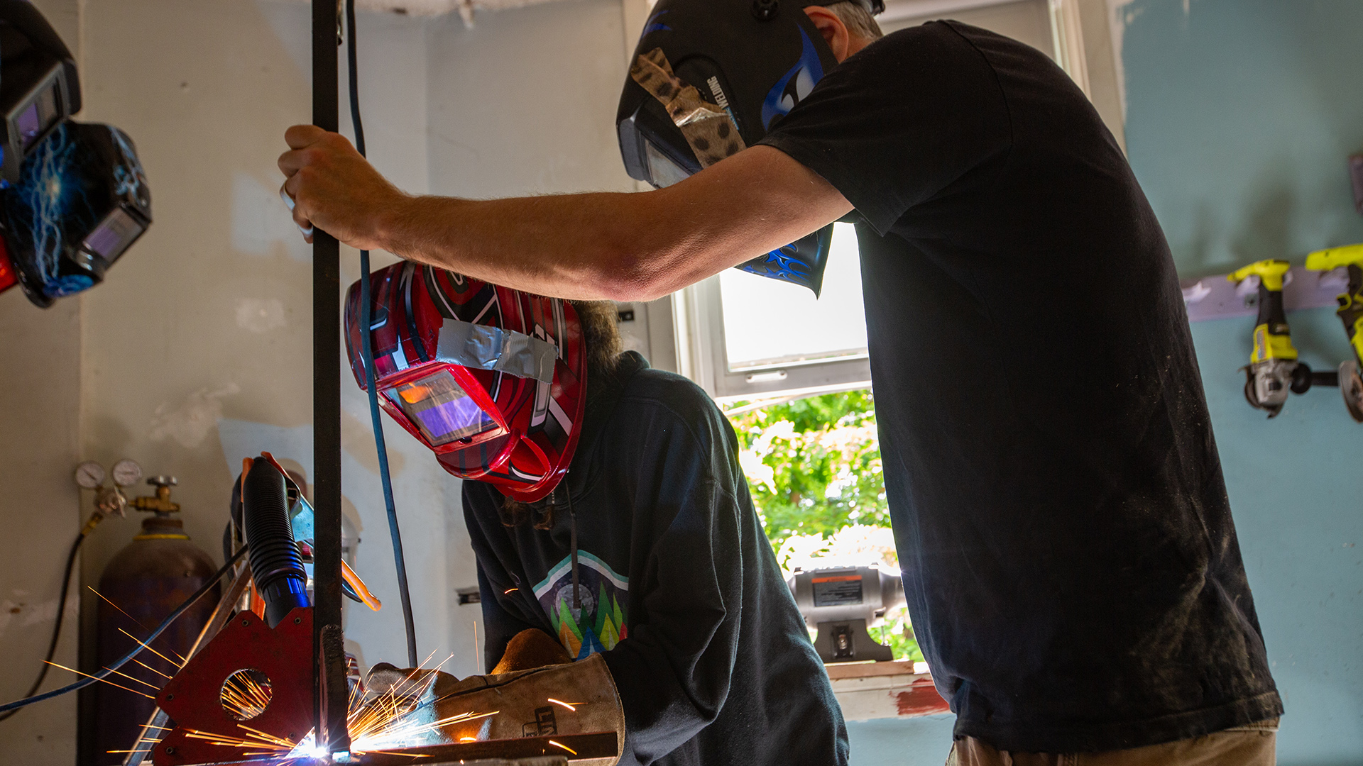 Two people use a table saw